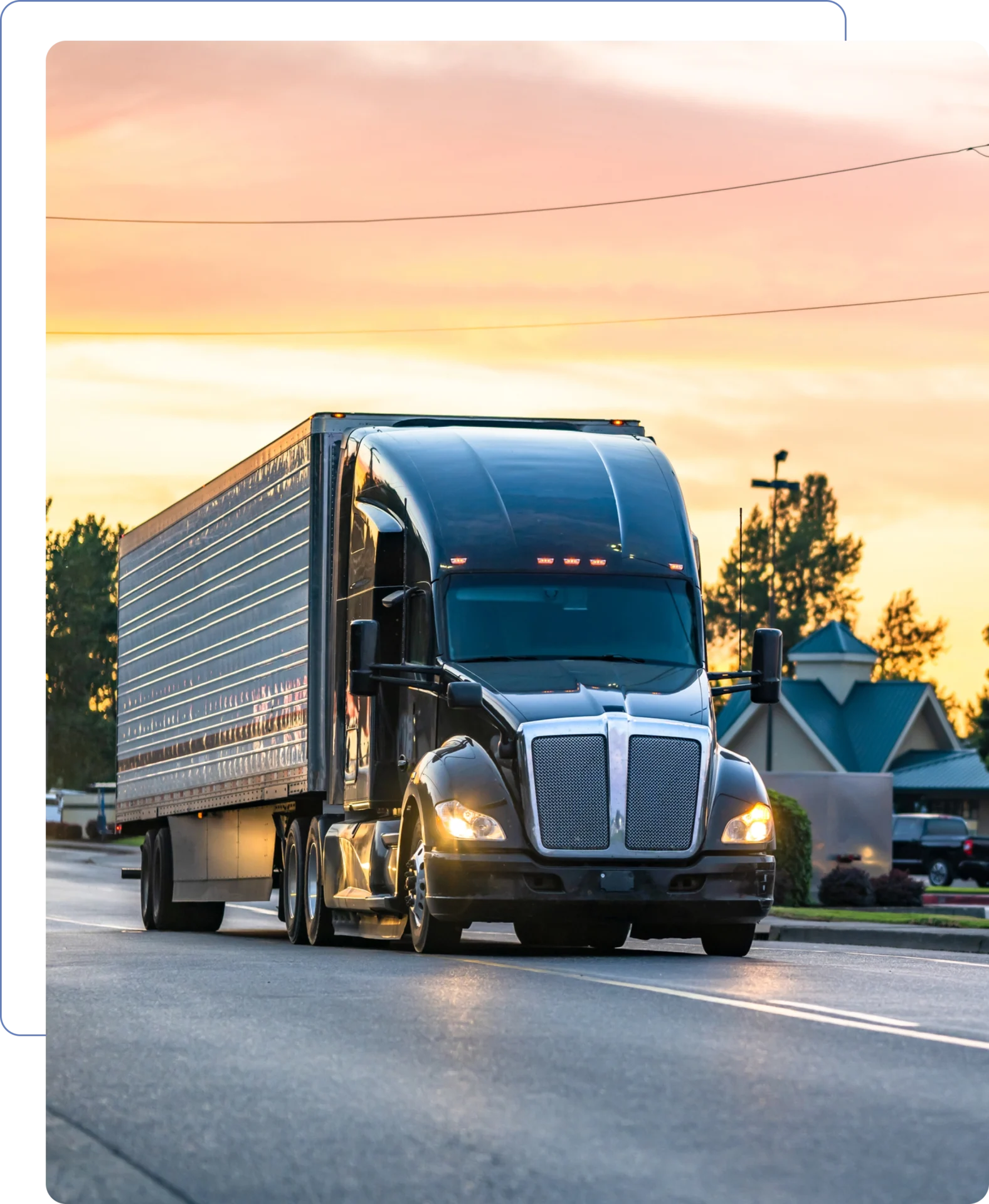 Truck driving on a road at sunset.